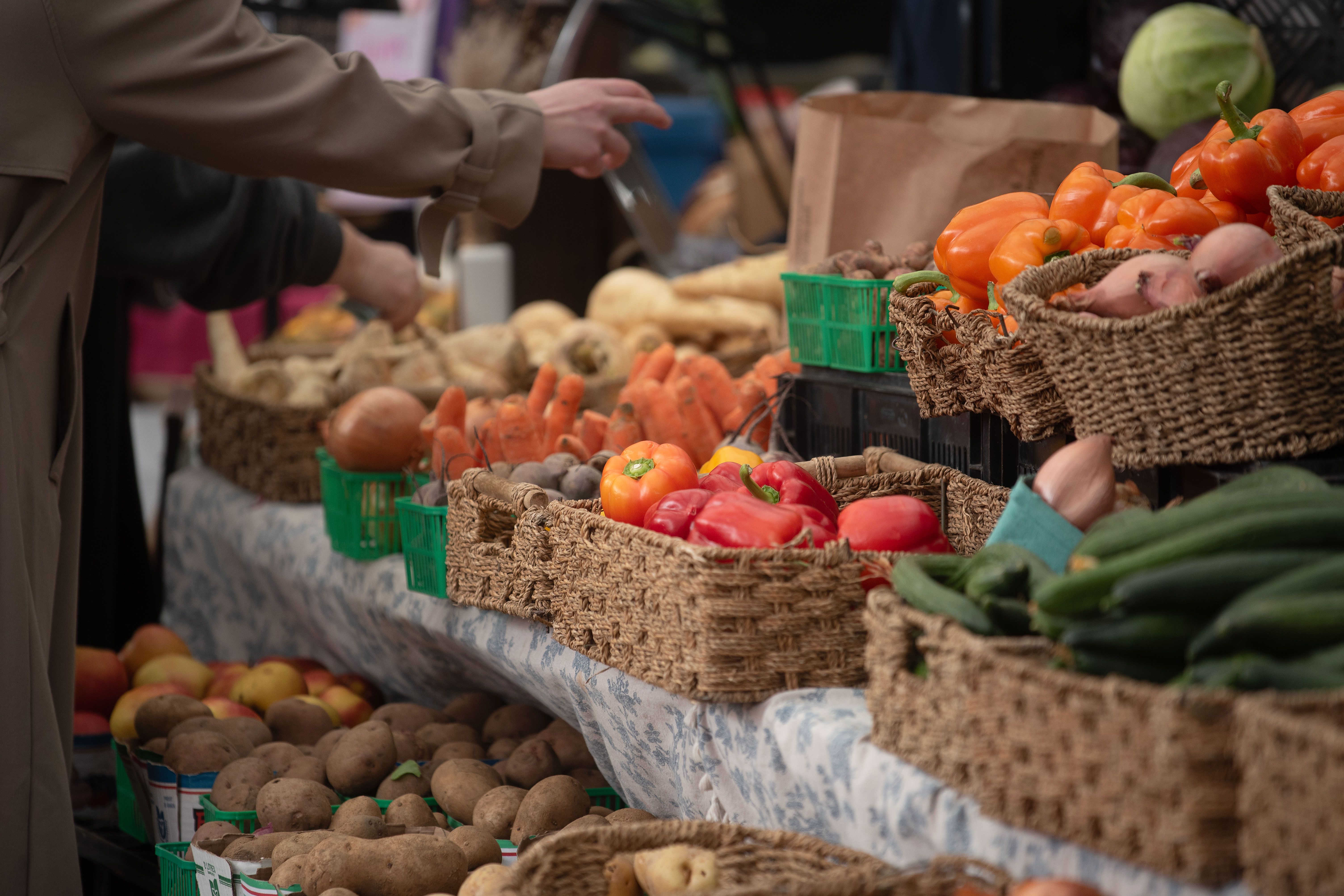 Farmers market stall with baskets of produce